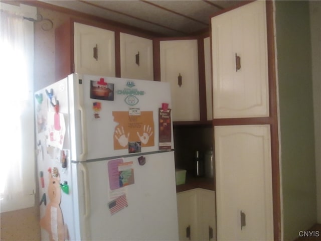 kitchen with white cabinets and white refrigerator