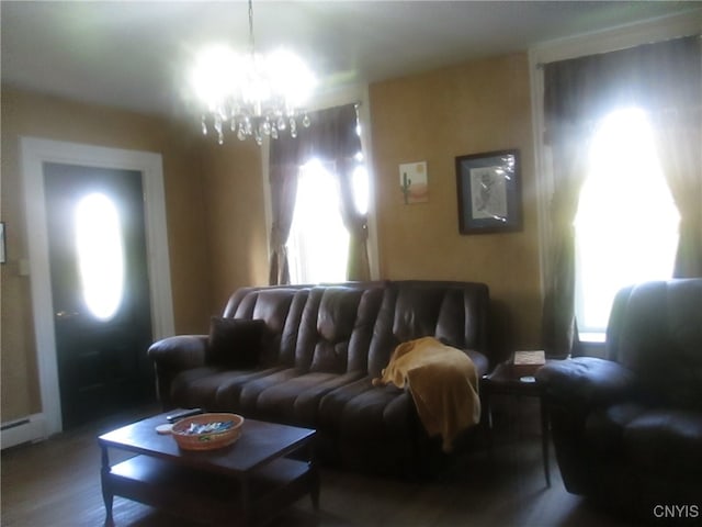 living room featuring wood-type flooring and an inviting chandelier