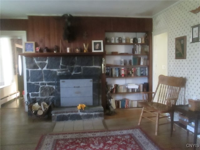 living room featuring a baseboard radiator, a fireplace, and crown molding