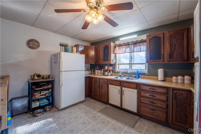 kitchen featuring white refrigerator, light tile patterned floors, a paneled ceiling, and ceiling fan