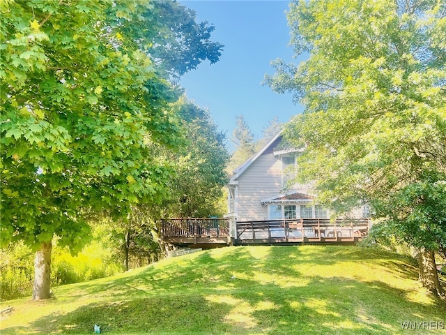 exterior space featuring a wooden deck and a yard