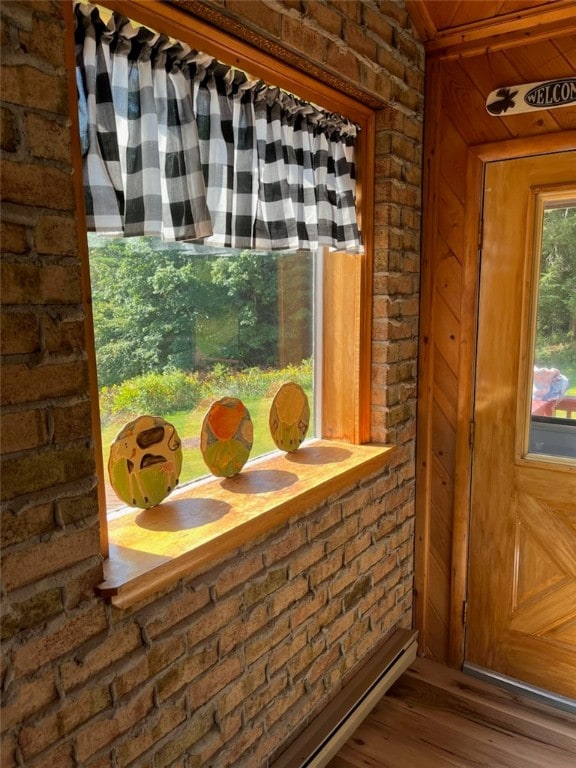 doorway featuring wood walls and hardwood / wood-style flooring