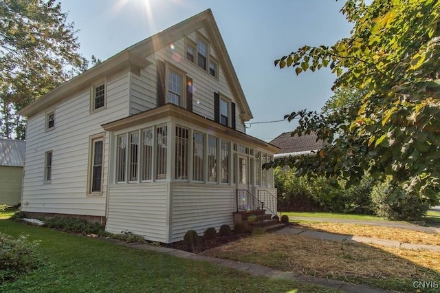 view of property exterior with a lawn