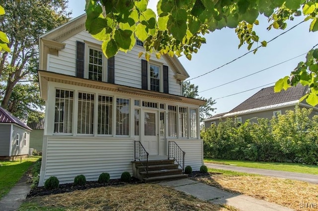 view of front of house featuring a sunroom