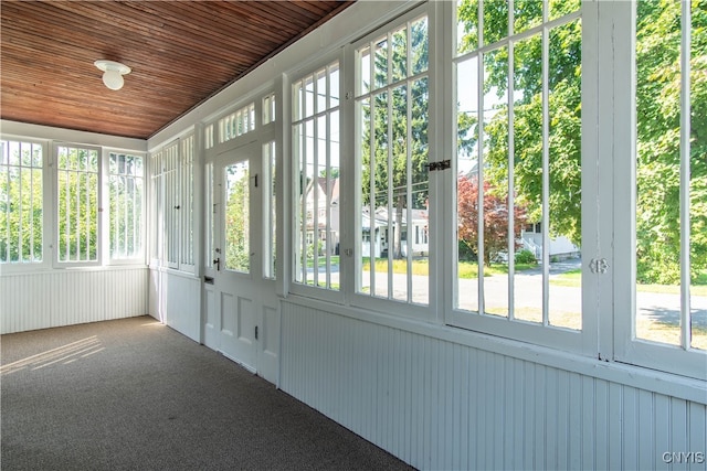 unfurnished sunroom with a wealth of natural light and wooden ceiling