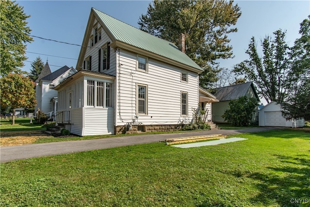 view of side of property featuring a yard and a garage