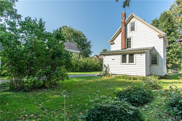 view of home's exterior featuring a yard