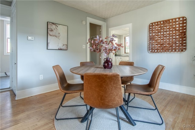 dining room featuring light hardwood / wood-style flooring and plenty of natural light