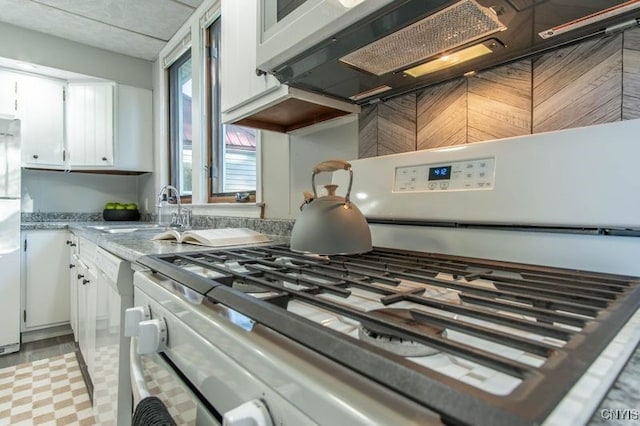 kitchen with white cabinetry, sink, and white appliances