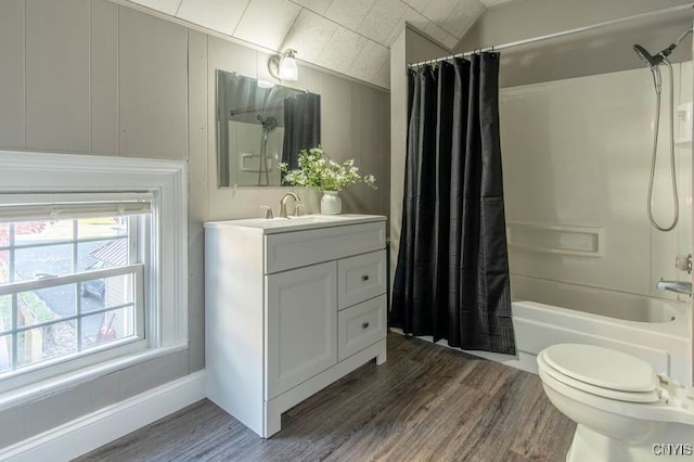 full bathroom featuring toilet, shower / bath combo with shower curtain, lofted ceiling, vanity, and hardwood / wood-style flooring