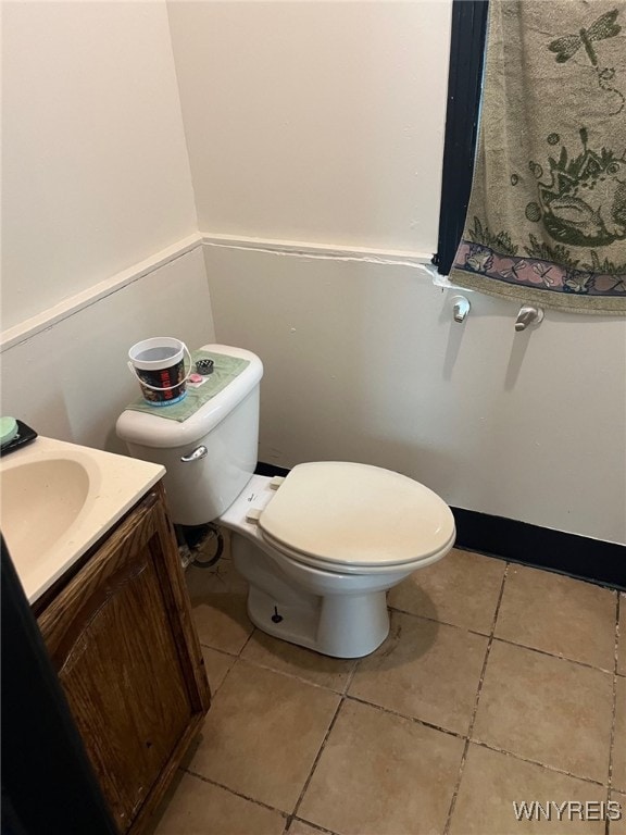 bathroom featuring vanity, toilet, and tile patterned floors