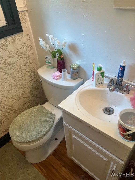 bathroom featuring vanity, toilet, and hardwood / wood-style flooring