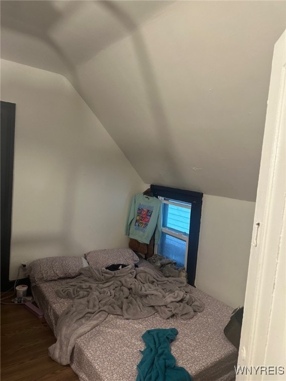 bedroom featuring wood-type flooring and lofted ceiling