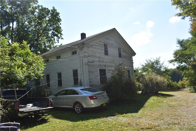 view of home's exterior with a yard