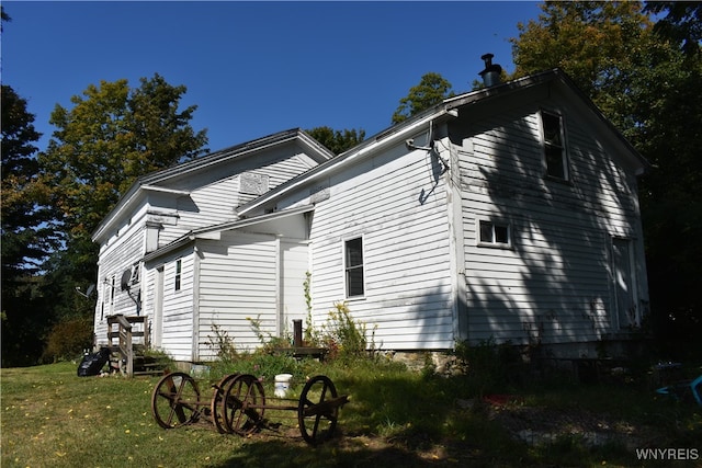 view of side of home featuring a lawn