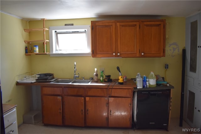 kitchen featuring black refrigerator and sink