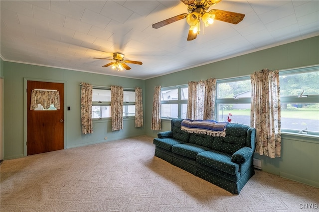 carpeted living room with crown molding, baseboard heating, and ceiling fan