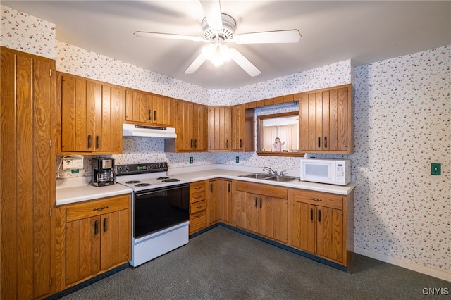 kitchen featuring white appliances, sink, and ceiling fan