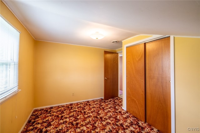 unfurnished bedroom with a closet and carpet