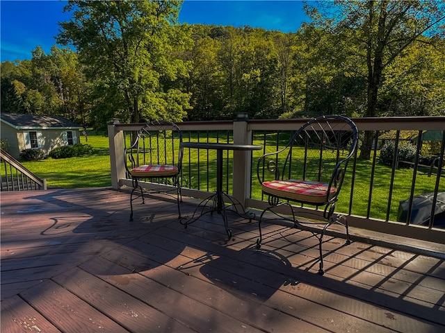 wooden deck featuring a yard