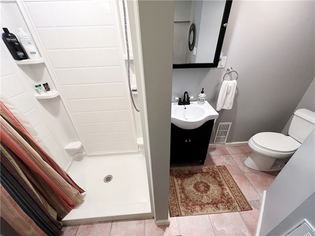 bathroom with walk in shower, vanity, and toilet