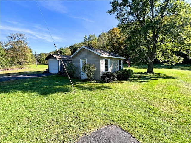 view of home's exterior featuring a yard and an outbuilding