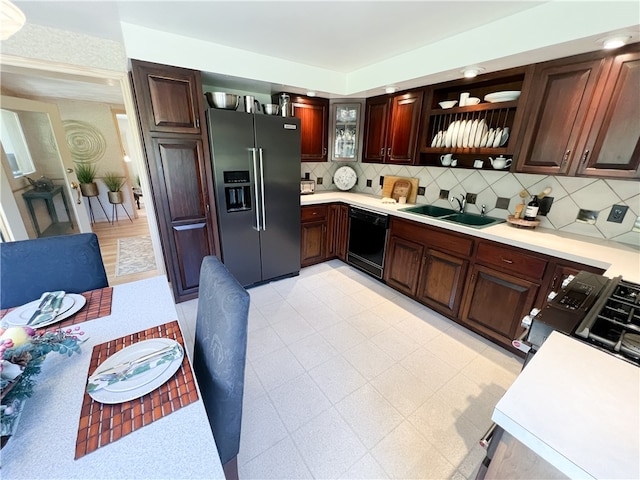 kitchen featuring black dishwasher, backsplash, sink, and stainless steel fridge with ice dispenser