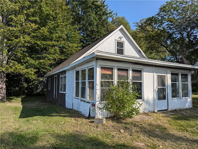 view of side of property with a lawn