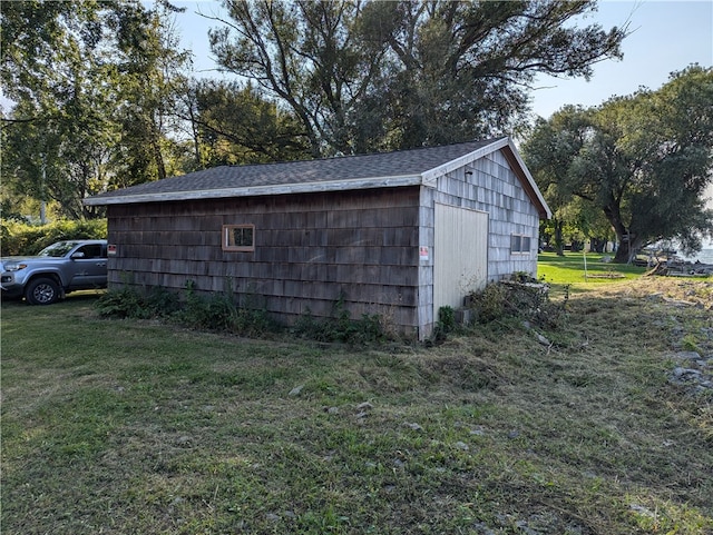 view of outbuilding with a lawn