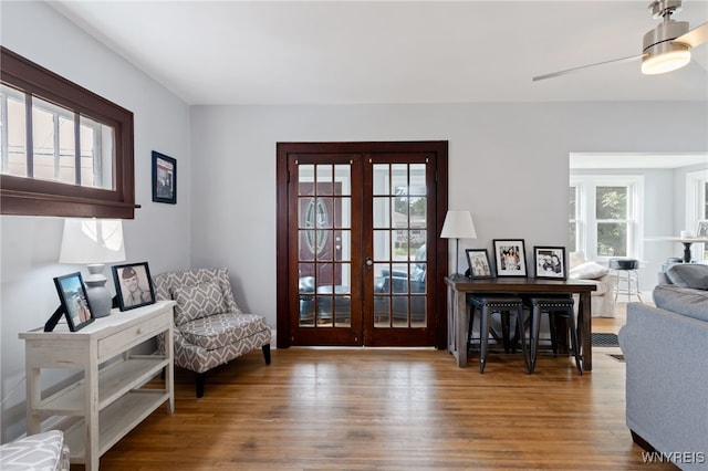 sitting room with french doors, plenty of natural light, and hardwood / wood-style floors