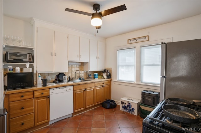 kitchen with dishwasher, sink, white cabinetry, ceiling fan, and stainless steel fridge