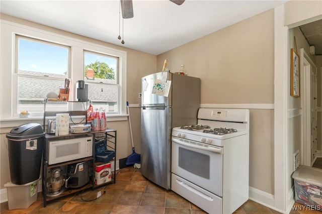 kitchen featuring ceiling fan and white appliances