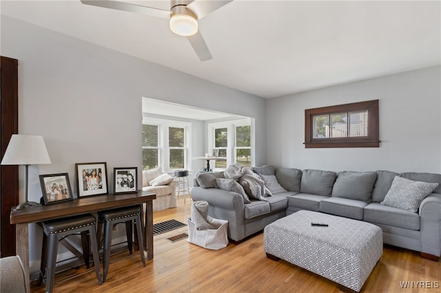 living room featuring wood-type flooring and ceiling fan