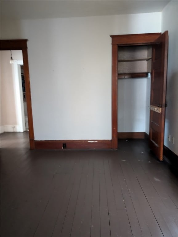 unfurnished bedroom featuring dark hardwood / wood-style floors