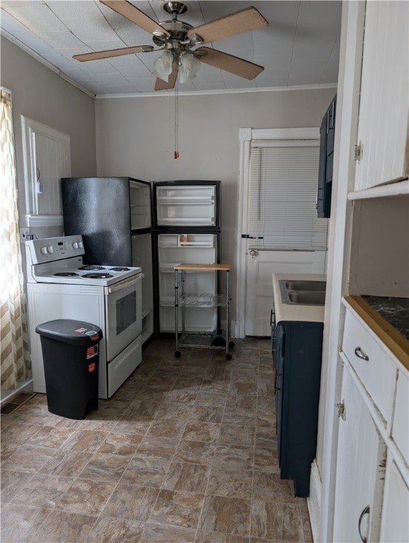 kitchen featuring ceiling fan, white cabinets, crown molding, and electric range