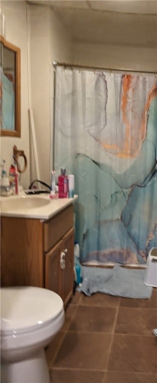 bathroom with tile patterned flooring, vanity, toilet, and a shower with shower curtain