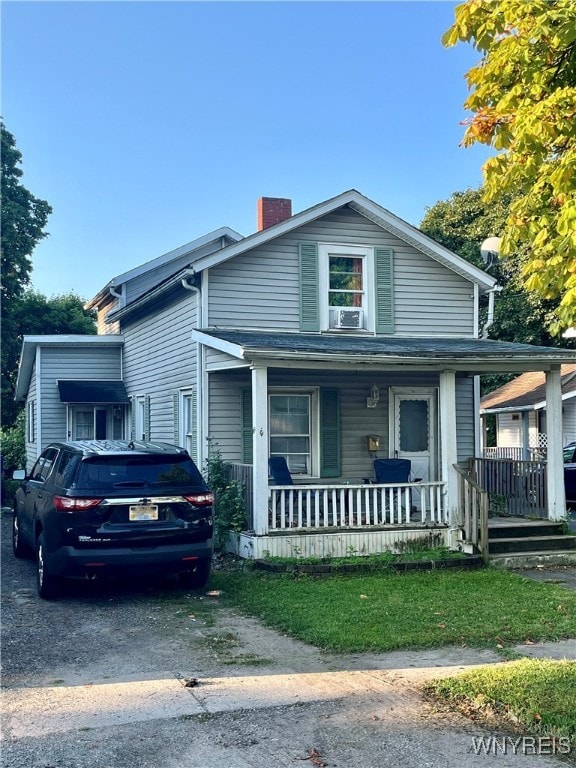 view of front of house with cooling unit and covered porch