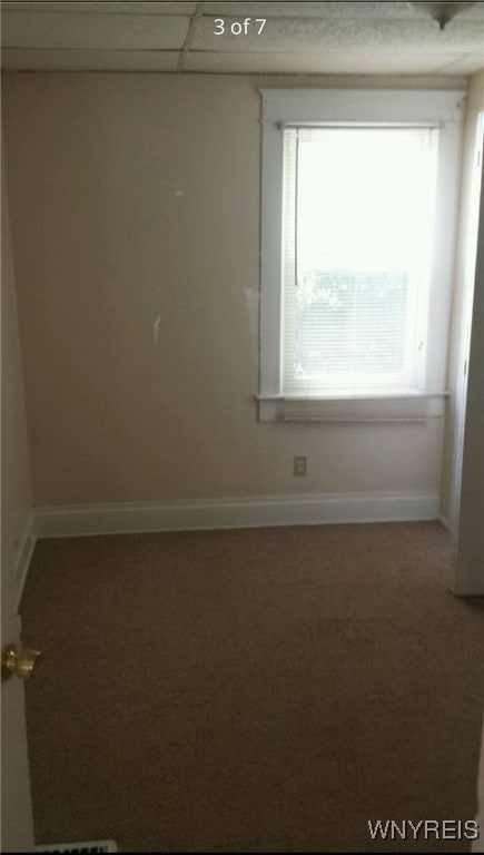 unfurnished room with a paneled ceiling