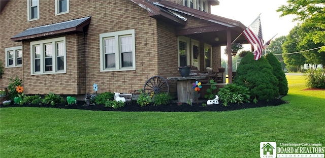 view of side of home featuring a yard