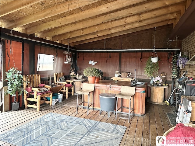 miscellaneous room with wood-type flooring, wooden walls, and lofted ceiling with beams