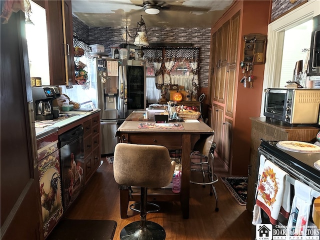 kitchen featuring dark hardwood / wood-style flooring, brick wall, stainless steel fridge with ice dispenser, and plenty of natural light