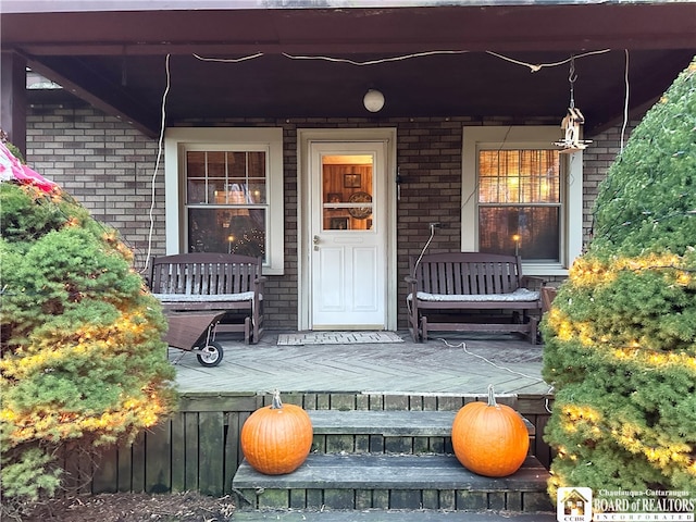 view of exterior entry featuring a porch