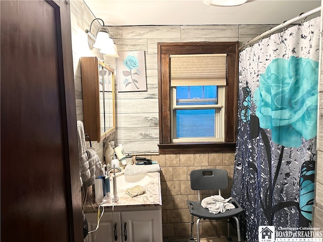 bathroom featuring walk in shower and vanity