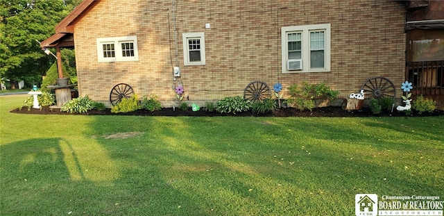 view of side of home with a yard