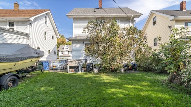 rear view of property with a yard