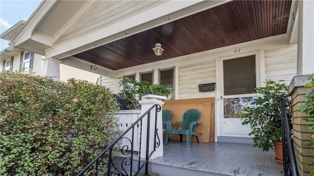 view of exterior entry with a porch