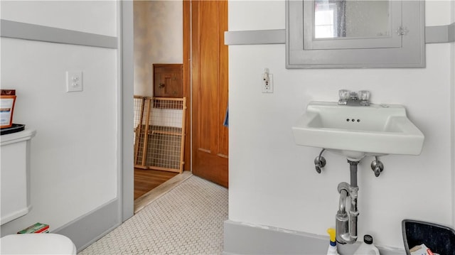 bathroom with toilet and tile patterned floors