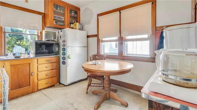 kitchen featuring white refrigerator and a healthy amount of sunlight