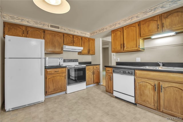 kitchen with white appliances and sink