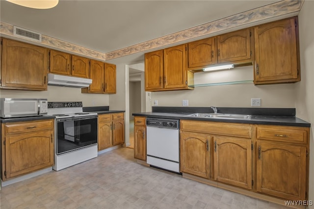 kitchen featuring white appliances and sink